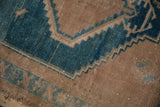 Distressed vintage Hamadan rug with worn dusty turquoise and camel geometric serrated lines.