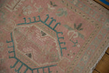 Distressed pink Karaja runner pile, showing faint foundation and blue geometric motifs.