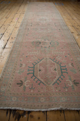 Distressed vintage Karaja runner with faded pink and dusty blue geometric patterns.