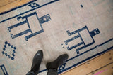 Distressed Oushak runner showing pale mauve pile to knot heads and cobalt geometric design.
