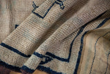 Textured, distressed pile of Oushak runner, with cobalt blue geometric lines and woven kilim edge.