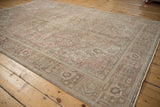 Distressed Tabriz carpet corner: rose pink, pale green patterns, even wear, faint foundation.