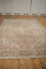 Distressed Tabriz carpet pile showing faded rose pink and coffee brown colors.