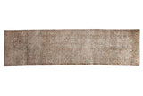 Distressed Oushak runner rug, muted geometric patterns in antique ivory and seafoam green.