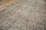 Detailed view of the distressed texture and subtle geometric floral motifs on the vintage Oushak runner.