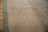Distressed Vintage Oushak rug detail showcasing abrashes, dusty raspberry, jade green, and lattice selvage.