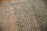 Heavy abrashes across the vintage distressed Oushak carpet, with green lattice motifs.