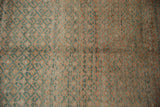 Distressed Oushak rug pile with faded raspberry and jade green lattice pattern abrashes.