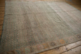 Close-up of vintage distressed Oushak rug pile, featuring subtle staggered buds and abrash colors.