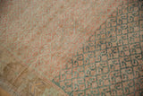 Distressed vintage Oushak rug pile with heavy abrashes, revealing faded raspberry and jade green motifs.