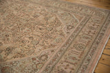 Distressed Tabriz rug close-up, geometric floral patterns, foundation wear, dusty rose, mint, brown.