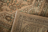 Vintage distressed Tabriz carpet showing its hand-knotted foundation and worn geometric pile.
