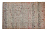 Distressed vintage Sivas hand knotted carpet with faded scrolling vinery and blush blossoms.