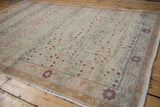 Distressed vintage Sivas carpet with scrolling vinery, blush flowers, and muted floral borders.