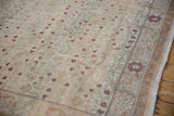 Distressed Sivas carpet with abrashed field, dusty rose blossoms, and a sandalwood floral border.