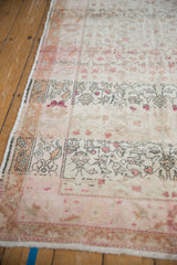 Distressed vintage Sivas rug with even pile wear, revealing soft floral designs and side selvage.
