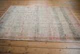 Distressed Sivas carpet lower border detail, with worn pile, sandy edge, and blush vinery.