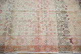 Lower section of distressed Sivas carpet showing faded floral vinery and dusty rose border.
