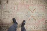 Distressed texture of the Oushak rug runner in soft pink and ivory tones.