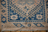 Detail of a vintage Turkish runner showing geometric borders and low pile with short, secured fringe.