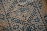 Evenly worn pile on a vintage Melas rug showing its blue hook-and-latch motif.