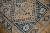 Evenly worn pile of a Turkish Melas runner with sand and blue hook-and-latch motifs.