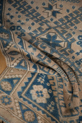 Close-up of the even wear and low pile texture on a distressed Turkish Melas rug runner.