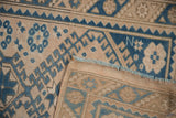 Folded corner detail of a distressed Turkish Melas runner showing its pile and flatweave back.