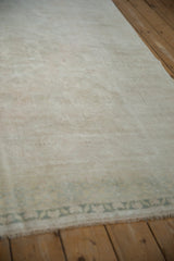 Soft, even pile of a distressed Oushak carpet showing ivory and sand-colored abrash.