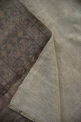 Fully secured side and hand-knotted back of a vintage Turkish Oushak carpet.