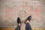 Distressed vintage Oushak runner with faded pink and antique ivory tones, showing natural wear.