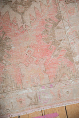Distressed Oushak runner texture, showing pink and ivory hues with exposed foundation.