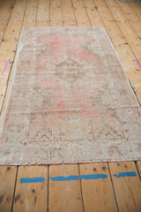 Hand-knotted Oushak runner's fringe, soft pink and beige distressed pile texture.