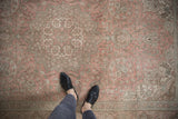 Distressed vintage Tabriz rug with dusty rose field and intricate pale floral vinery.
