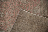 Distressed Tabriz carpet pile with faded floral patterns, exposing its woven foundation.