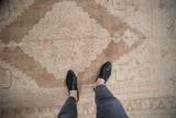 Distressed texture and stepped Oushak pattern in pale coffee, blush, and ivory shades.