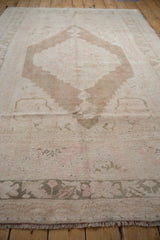 Distressed Oushak carpet pile texture, fringe, and muted coffee brown border.