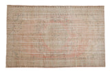 Distressed vintage Oushak carpet with soft pink, green, and ivory floral medallion, 6'2