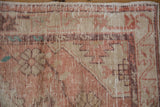 Worn hand-knotted pile and original selvage detail on a vintage Oushak rug corner.