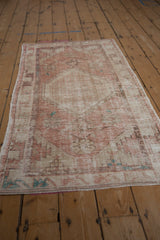 Vintage Oushak runner with a time-softened pink and ivory palette, seen from a full-length angle.