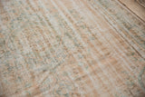 Distressed pile of vintage Oushak carpet, showing wear to foundation, blush, and dusty green.