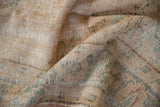 Distressed vintage Oushak rug with worn pile texture and soft ivory, tan, and green colors.