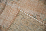 Distressed blush Oushak rug pile texture with original selvage and woven reverse.