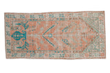 Vintage distressed Oushak runner with a prayer design in pale melon, turquoise, and sea foam green.