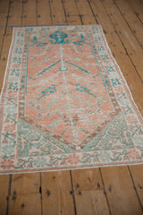 Full perspective view of a vintage Oushak runner showing its unidirectional prayer design.