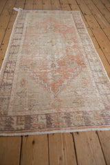 Distressed pile and faded floral cross-section of a vintage Oushak rug runner.