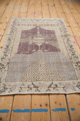 Distressed vintage Sparta rug detail, lower field with diamond pomegranate motif in silver and aubergine.