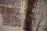 Distressed vintage Sparta rug's hand knotted pile texture in aubergine and platinum.