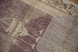 Distressed pile of the vintage Sparta rug showing aubergine, silver, and charcoal shades.