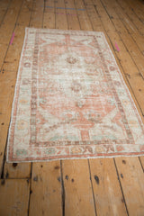 Hand-knotted distressed Oushak rug runner with faded peach, ivory, and teal geometric medallion.